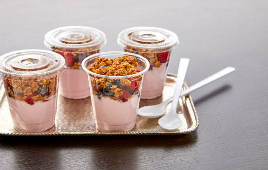 Tray of Strawberry Yoplait yogurt parfaits with fruit and Nature Valley granola toppings.