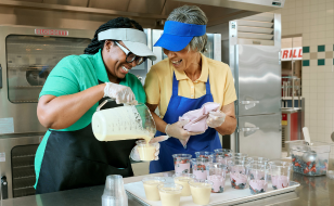 Two operators making parfaits and smoothies in school kitchen