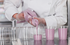 chef filling plastic glasses with smoothies